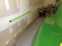 Pool noodle cut in half & attached to the garage walls on both sides to protect the door from hitting the walls