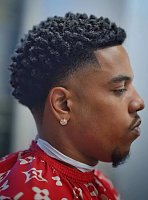 A fade haircut  is a popular men's hairstyle where the hair is cut very close to the scalp at the bottom and gradually gets longer as it goes up the sides and back of the head