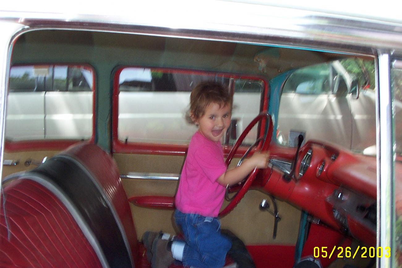 My g-daughter Alyssa driving my '57 Chevy